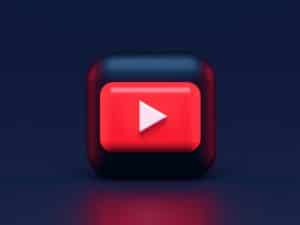 Un bouton YouTube rouge sur fond sombre.